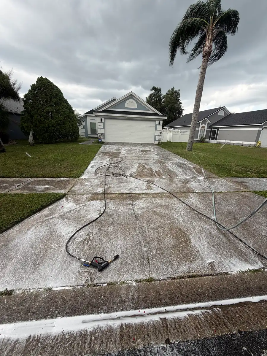 A driveway halfway through a pressure wash